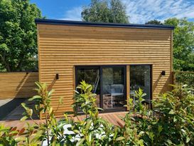 New house with large wooden deck, next to the sea